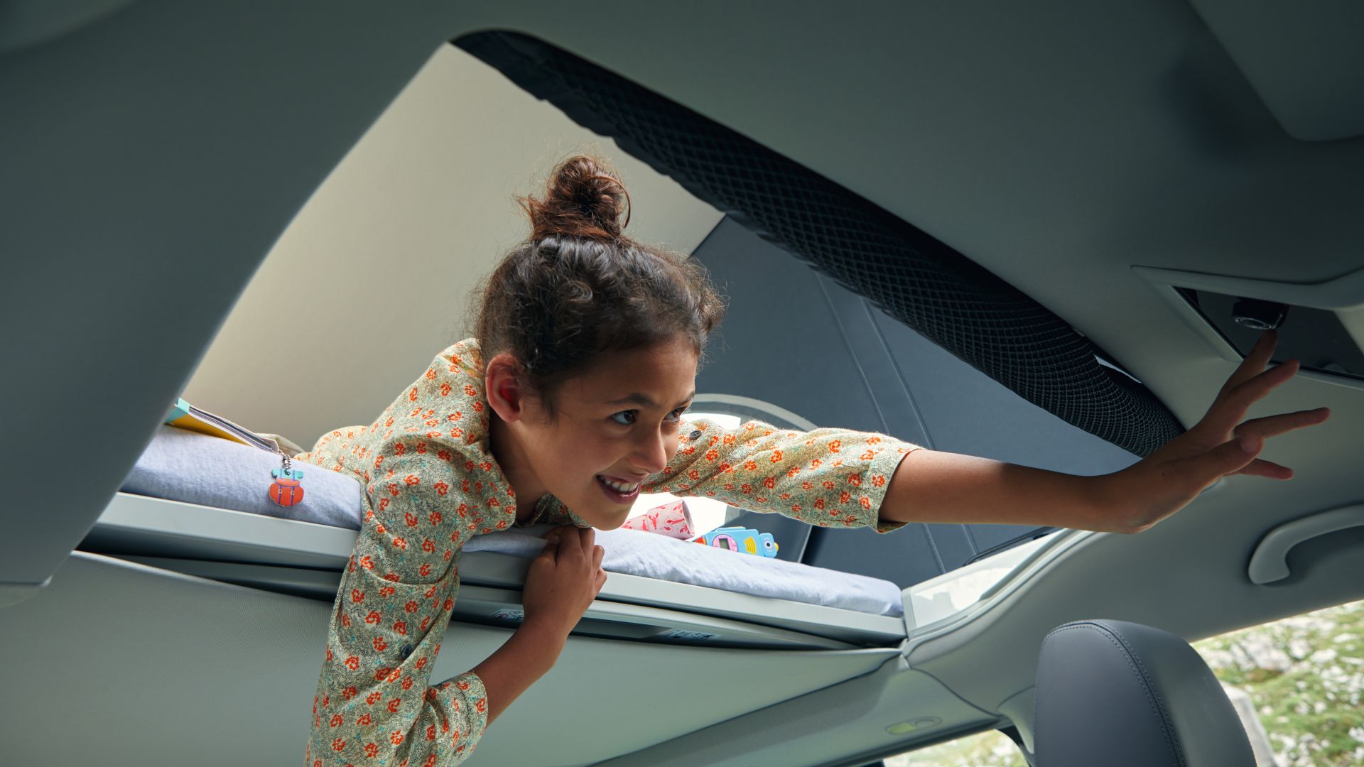 Girl looking down from the VW California Ocean pop-up roof