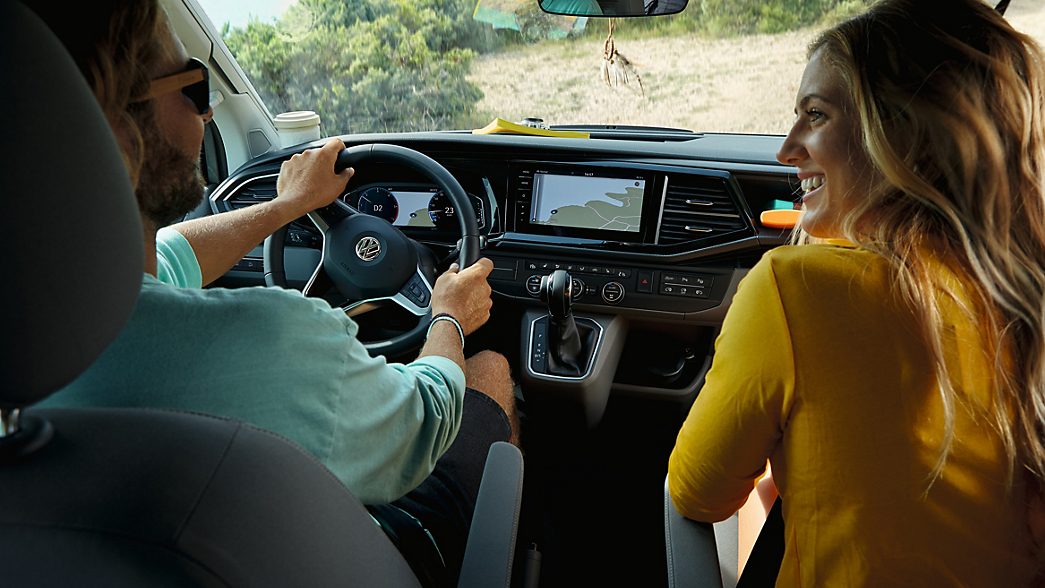 AMAG VW ID. Buzz with woman and man sitting inside and connecting their smartphone