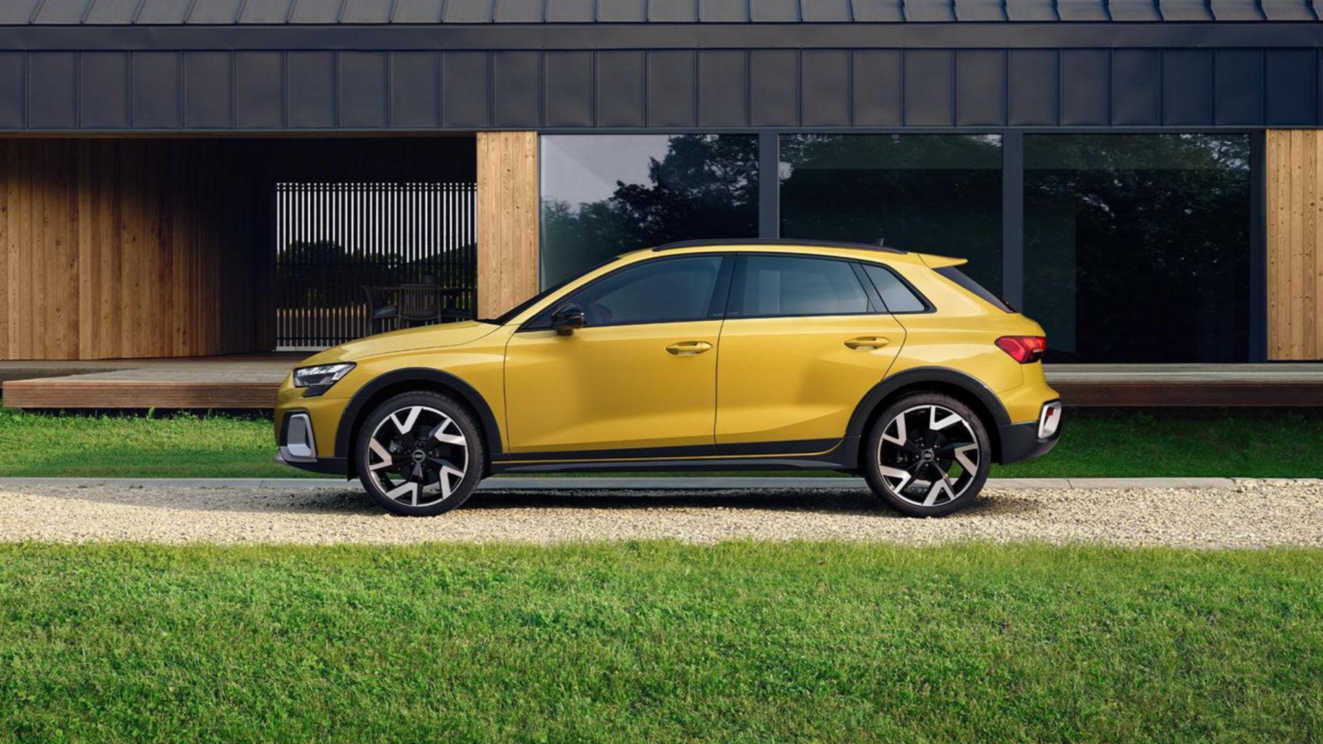 Yellow Audi A3 allstreet parked in front of a house side view