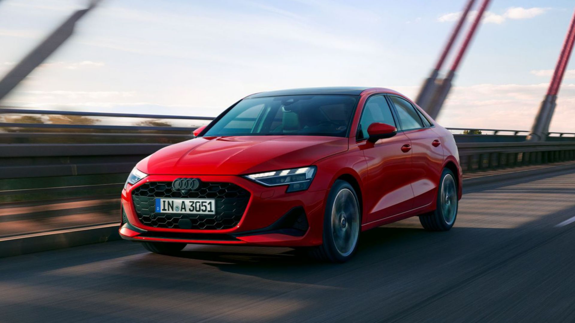 Red Audi A3 saloon on the street front and side view