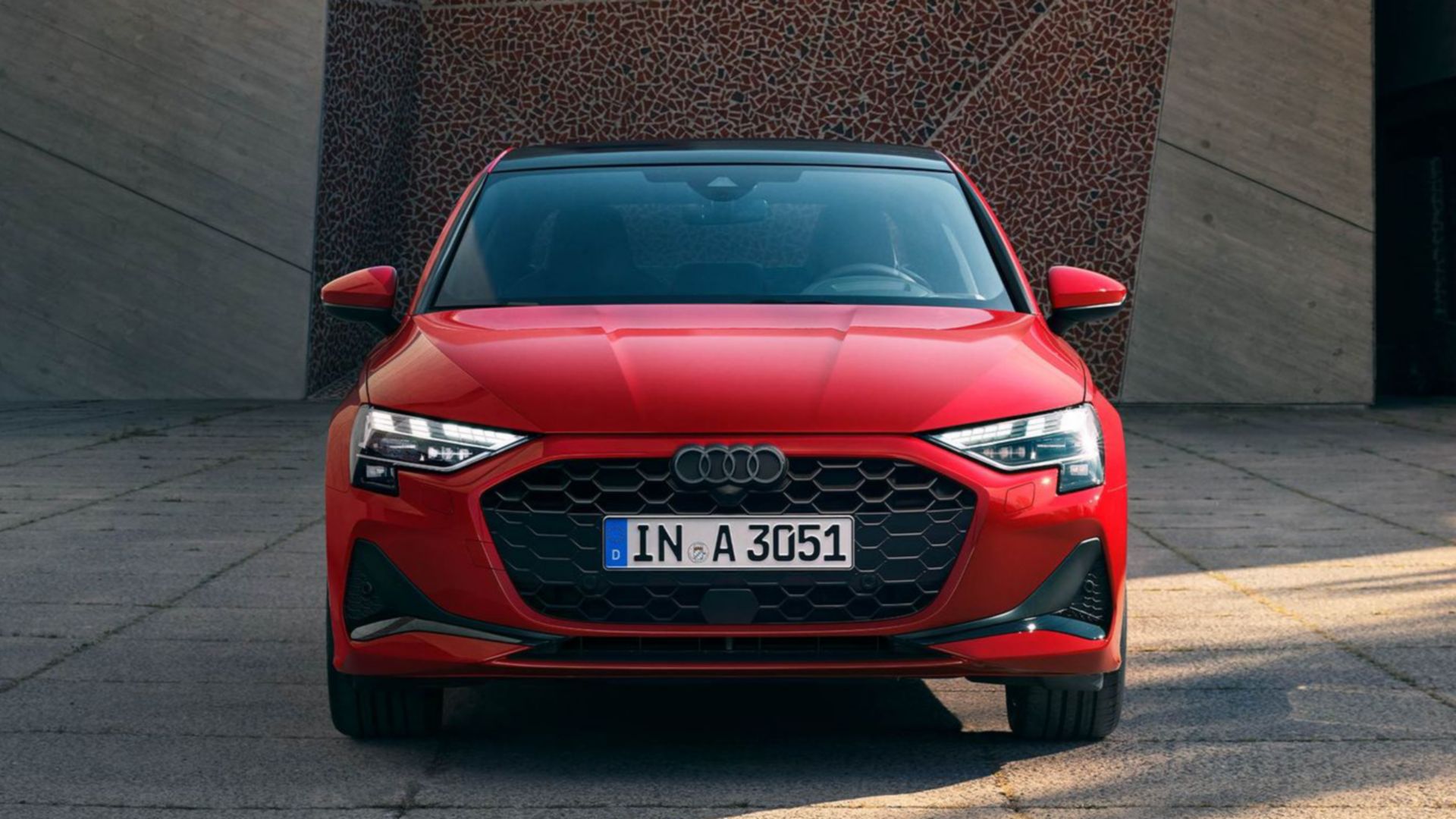 Red Audi A3 saloon front view