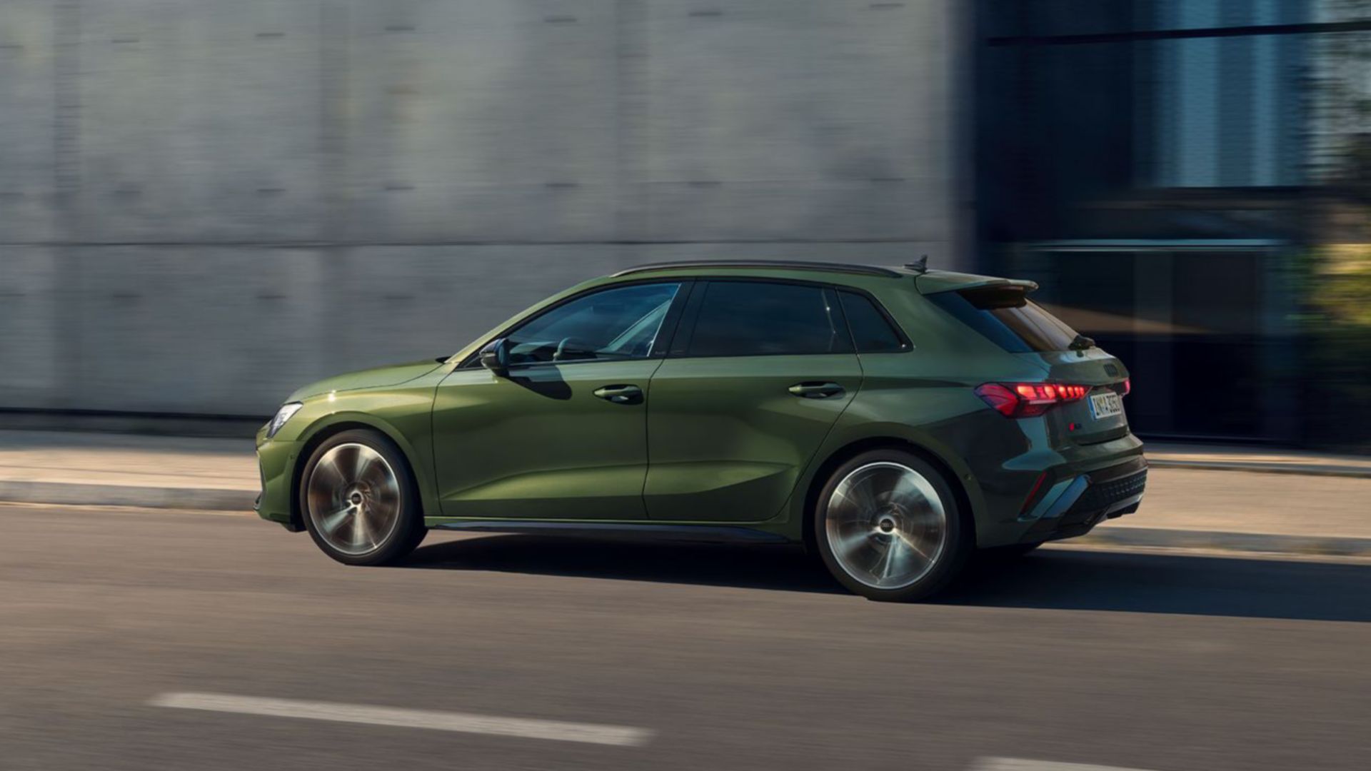Green Audi A3 Sportback on the street side view 
