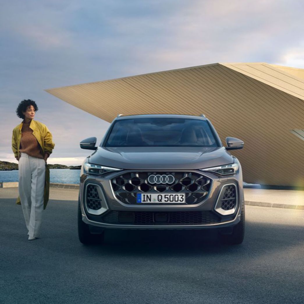 Black Audi Q5 front view with a woman