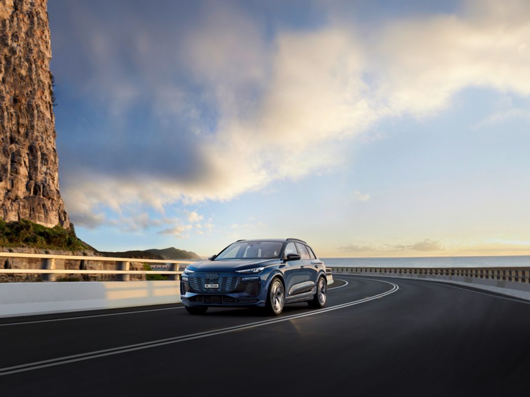 Grey Audi Q6 e-tron side view on a country road