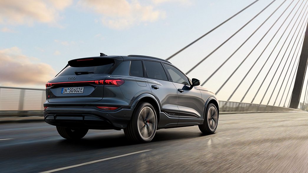 Audi Q8 e-tron Sportback rear side view with charging station