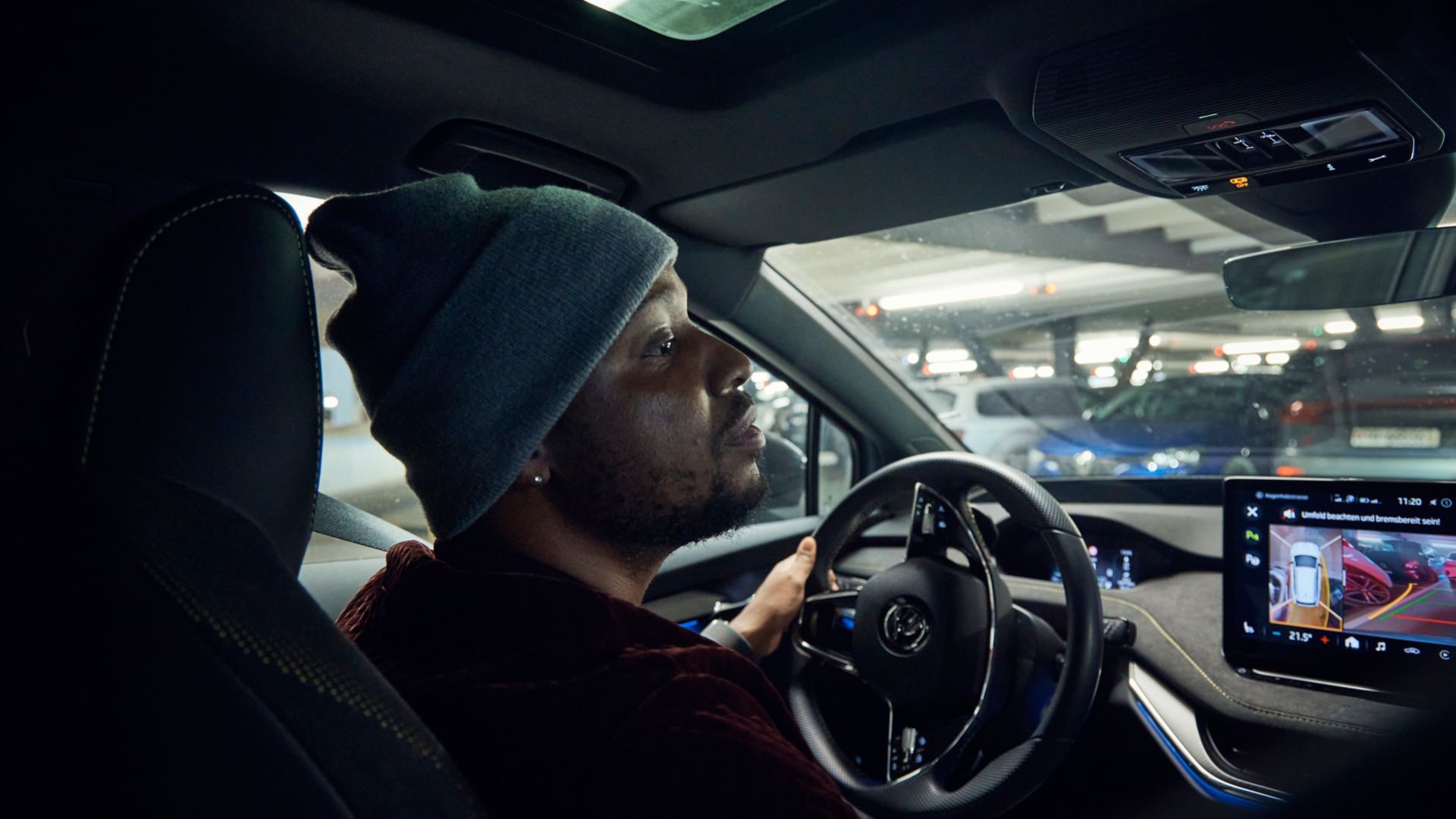 Charles Nguela parking an electric AMAG car