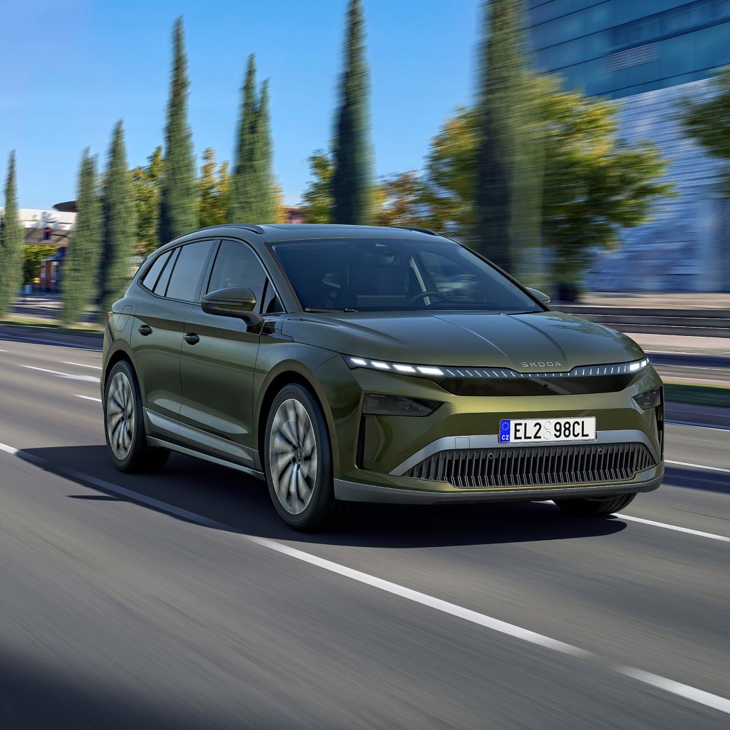Green Skoda Enyaq front and side view on a street