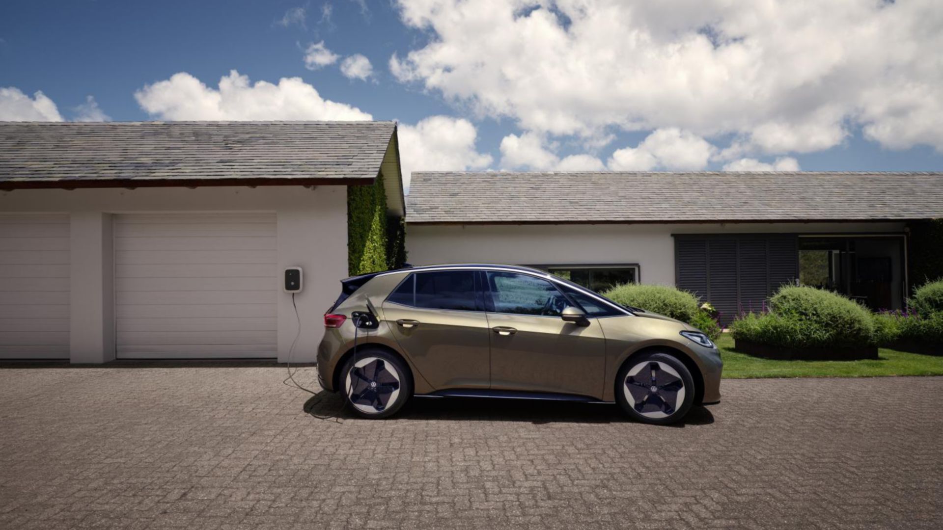 Olivgrüner VW ID.3 an Home-Ladestation Seitenansicht