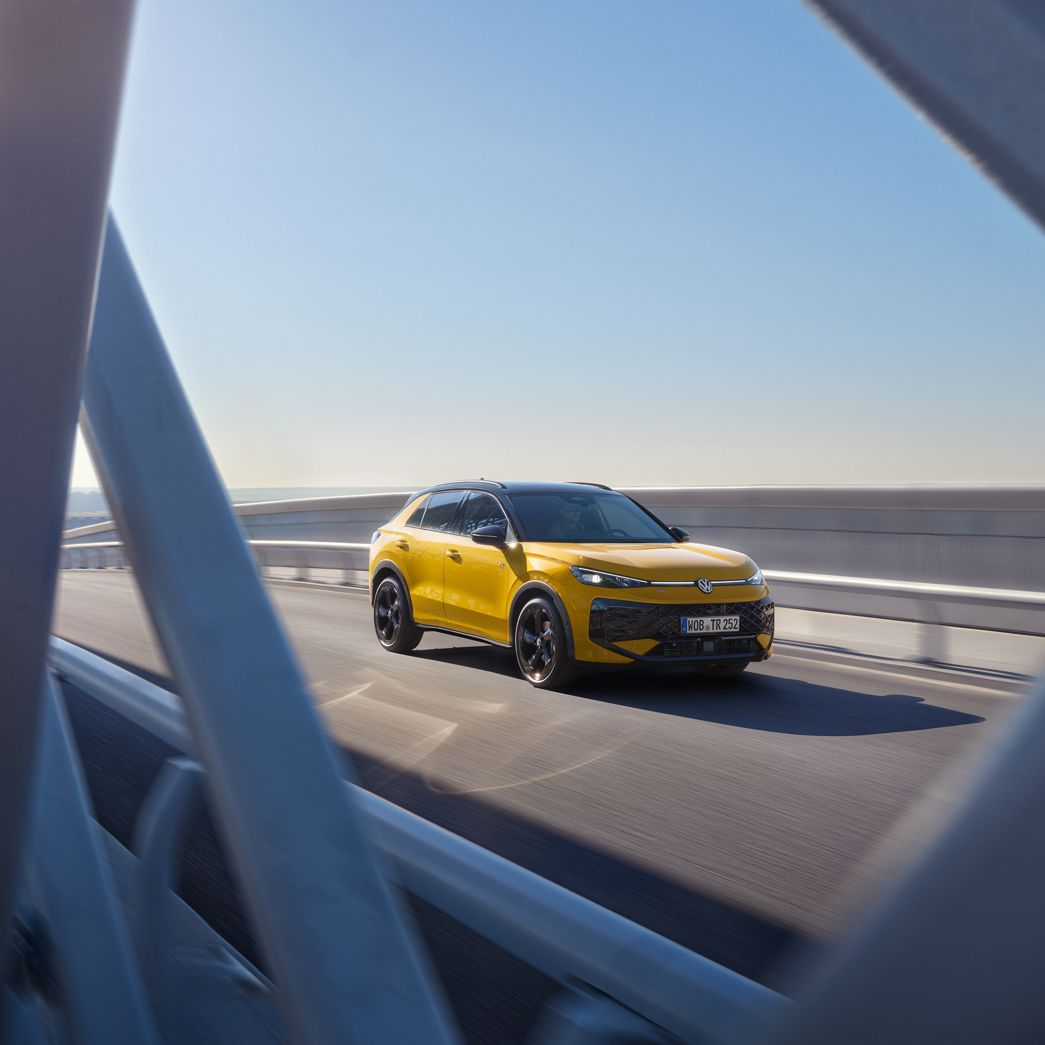 Yellow VW T-Roc side and front view on a bridge