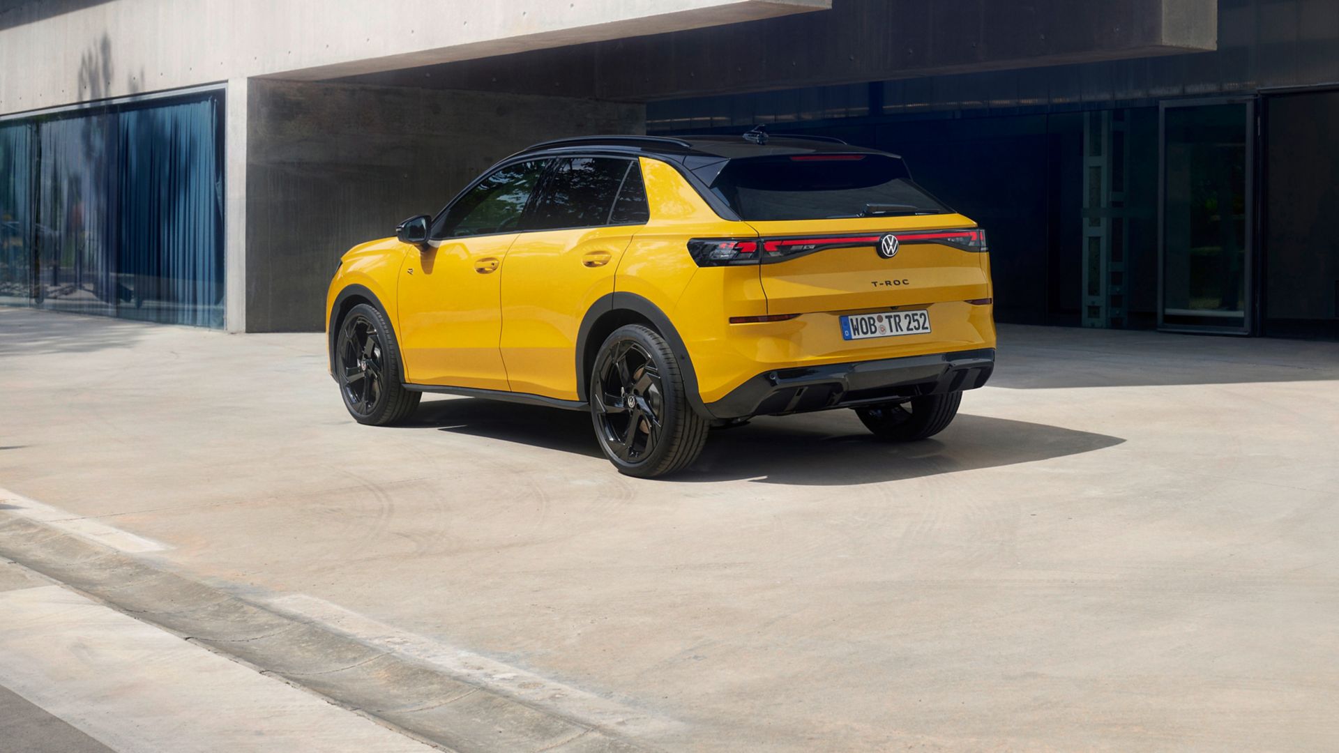 VW T-Roc side and rear view in front of a building