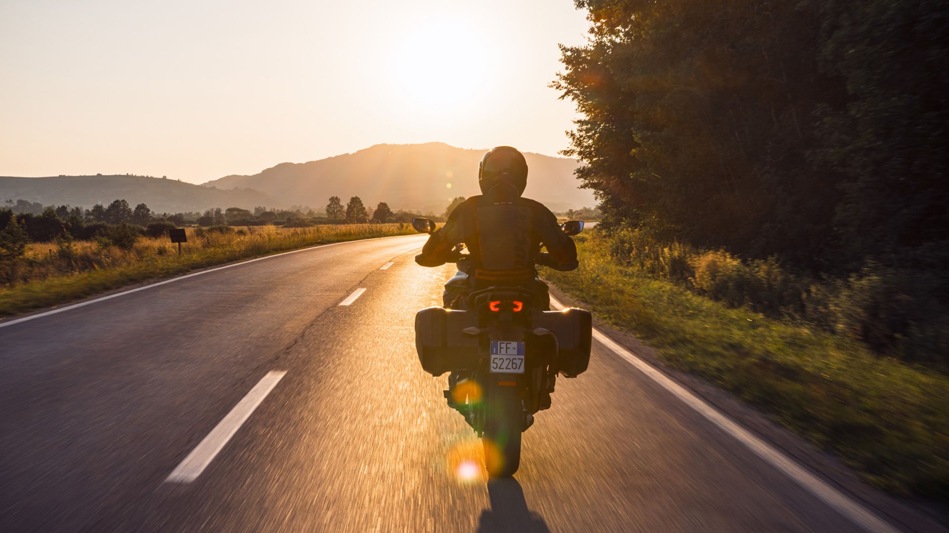 Ducati rider on the road at sunset