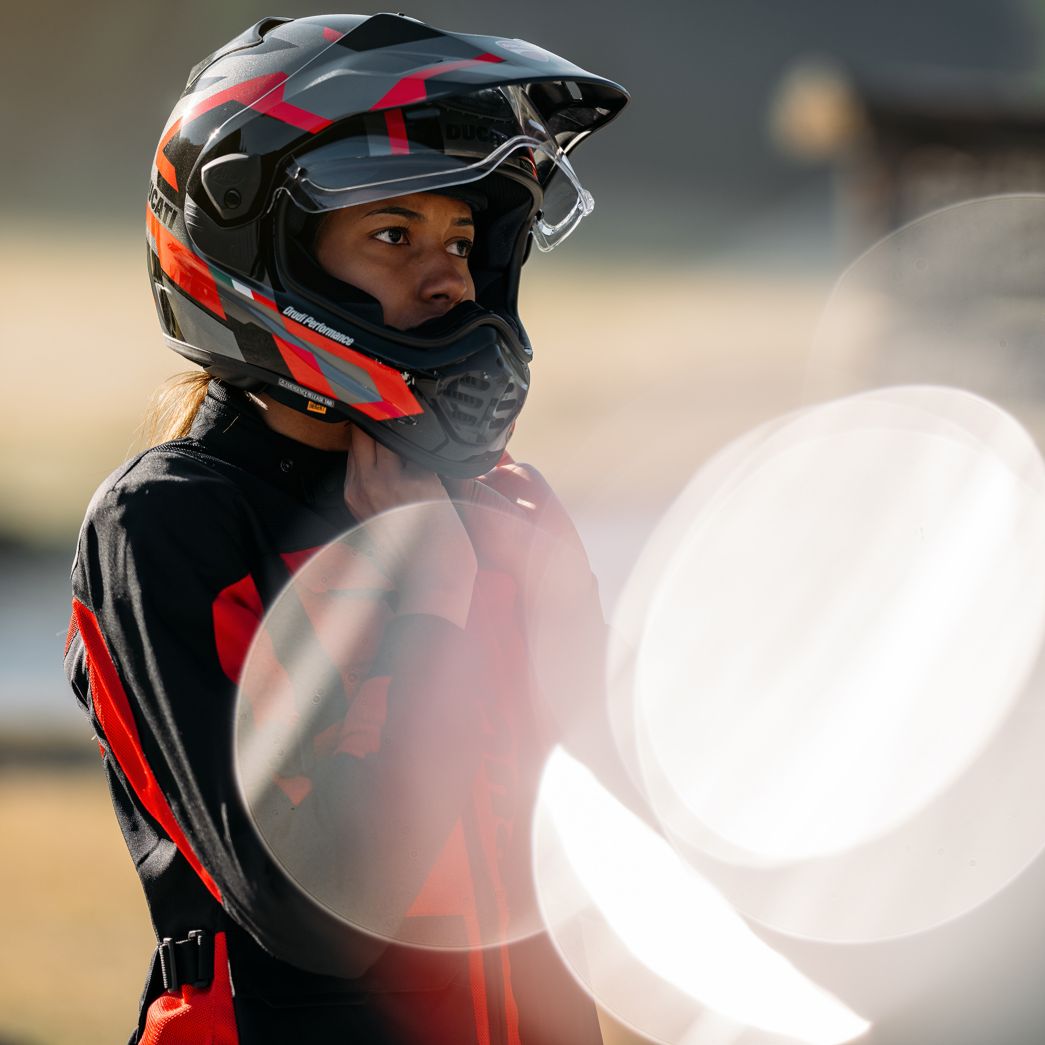 Frau zieht Motorradhelm auf